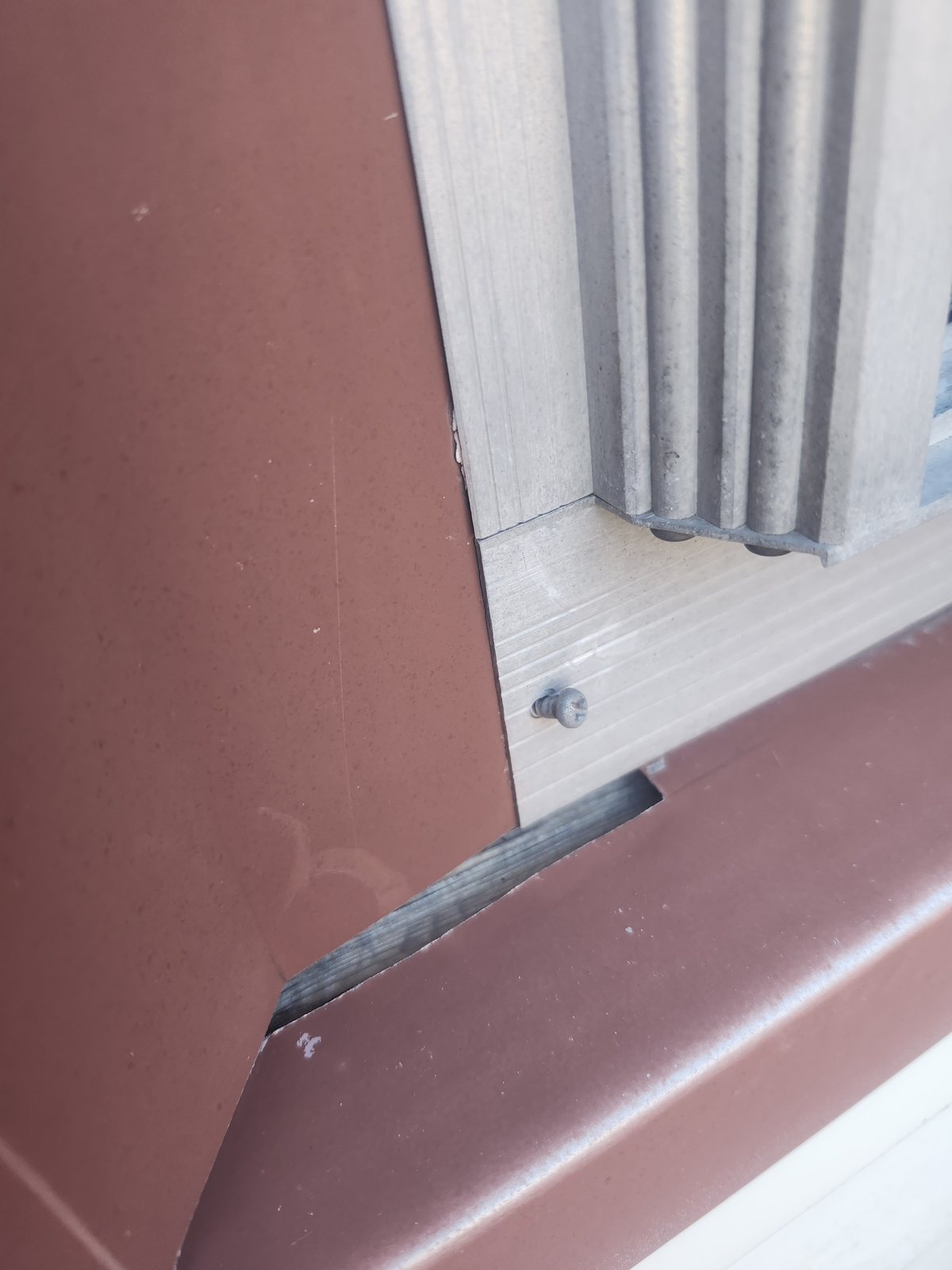 Brown metal trim installed at a window corner