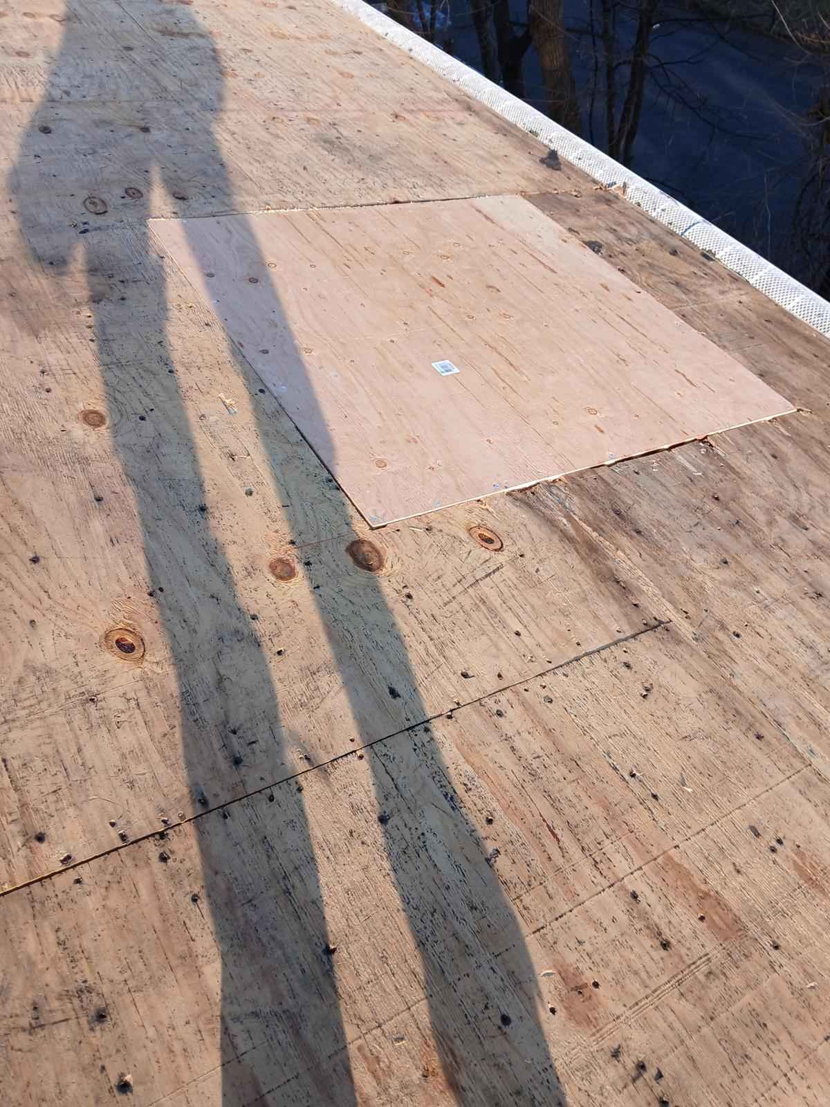 New plywood patch installed on a roof deck